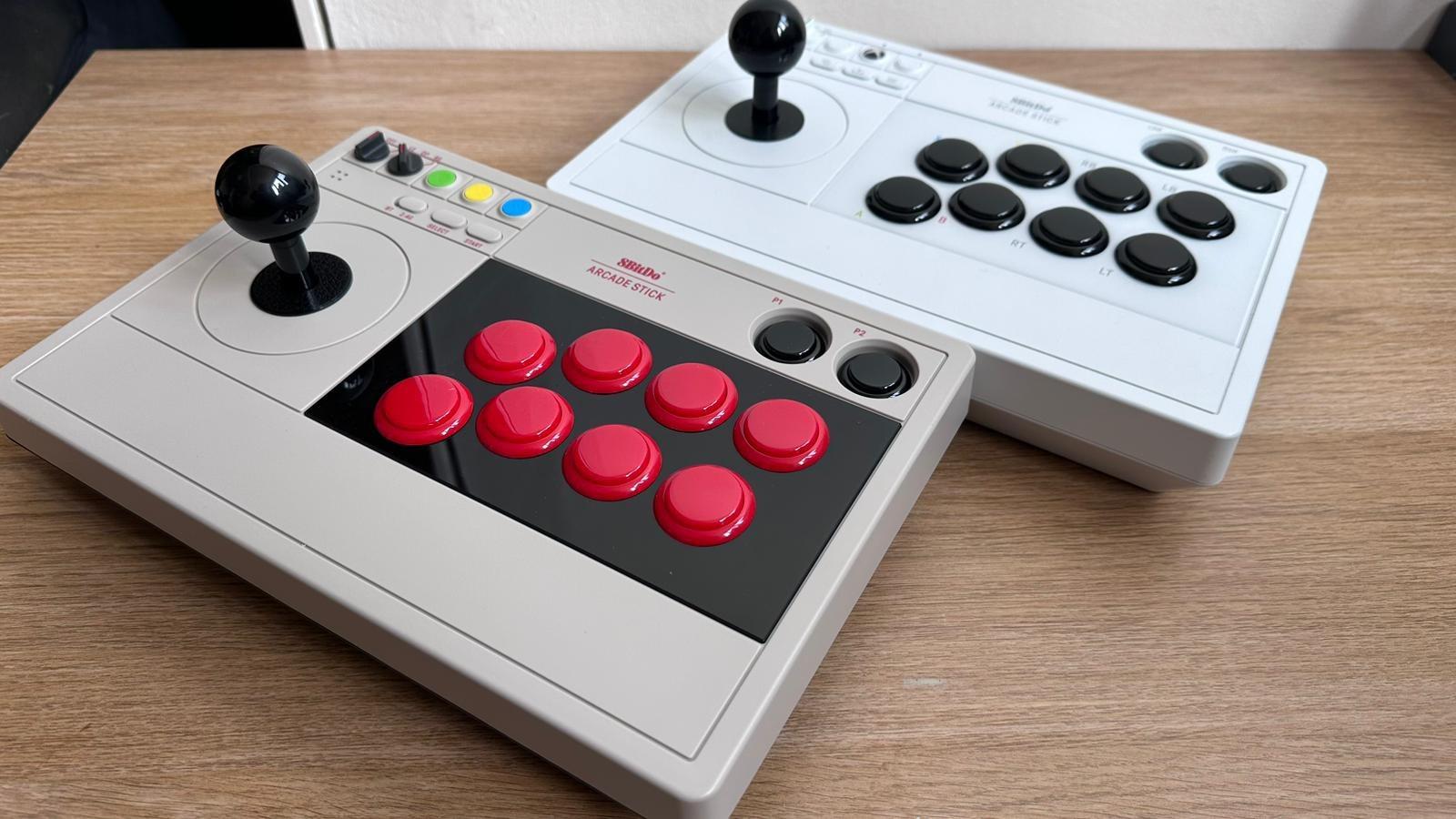 The 8BitDo Arcade Sticks next to each other on a table