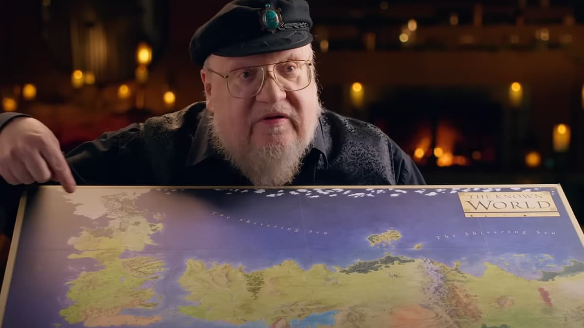 George R.R. Martin with a Westeros map