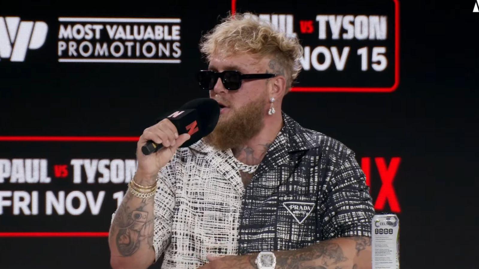 Jake Paul talking at Netflix press conference in sunglasses