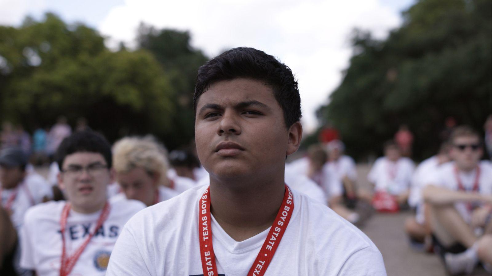 One of the subjects in Boys State sits with other participants.