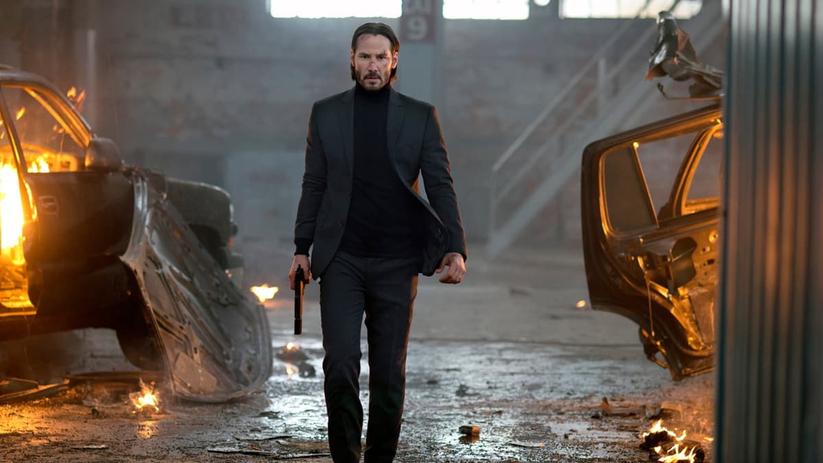 Keanu Reeves holding a gun in John Wick.