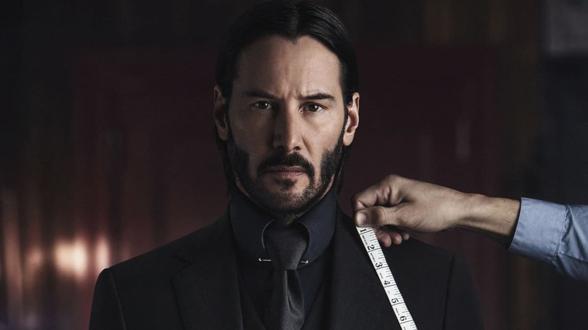 Keanu Reeves is measured for a suit in John Wick: Chapter 2