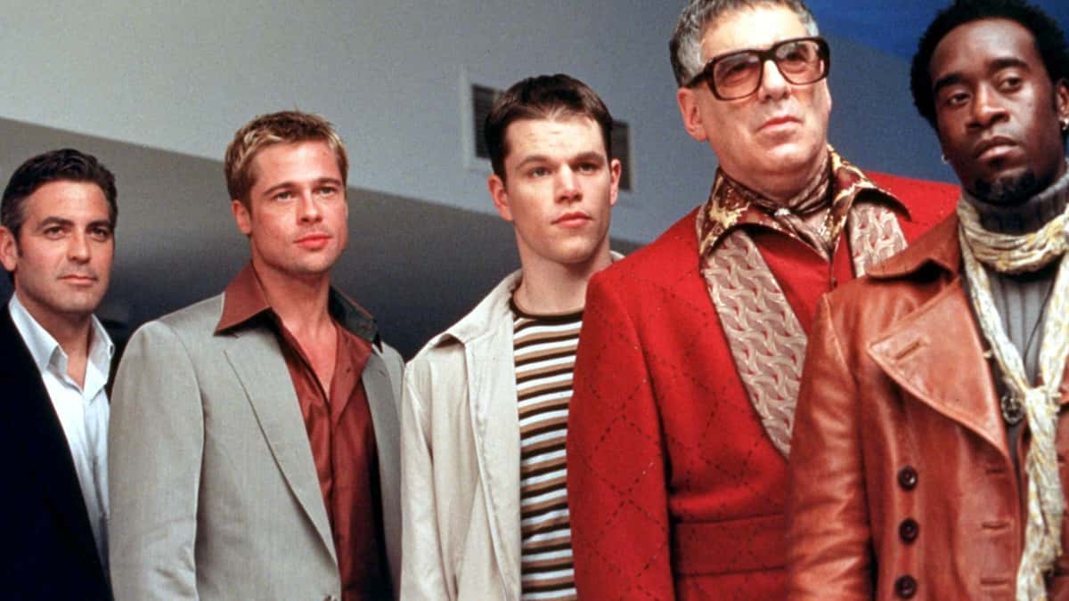 The Ocean's 11 ensemble in a line, including George Clooney and Brad Pitt on the left.