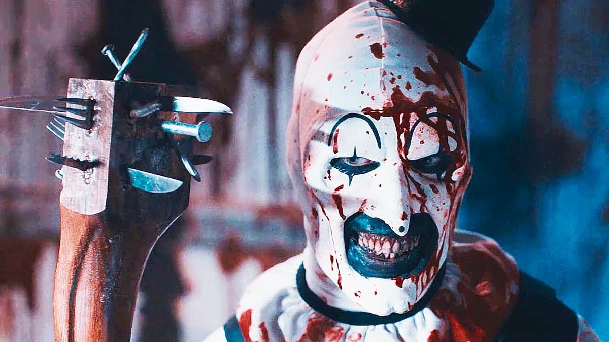 Art the Clown holding a bat full of nails in Terrifier 2.