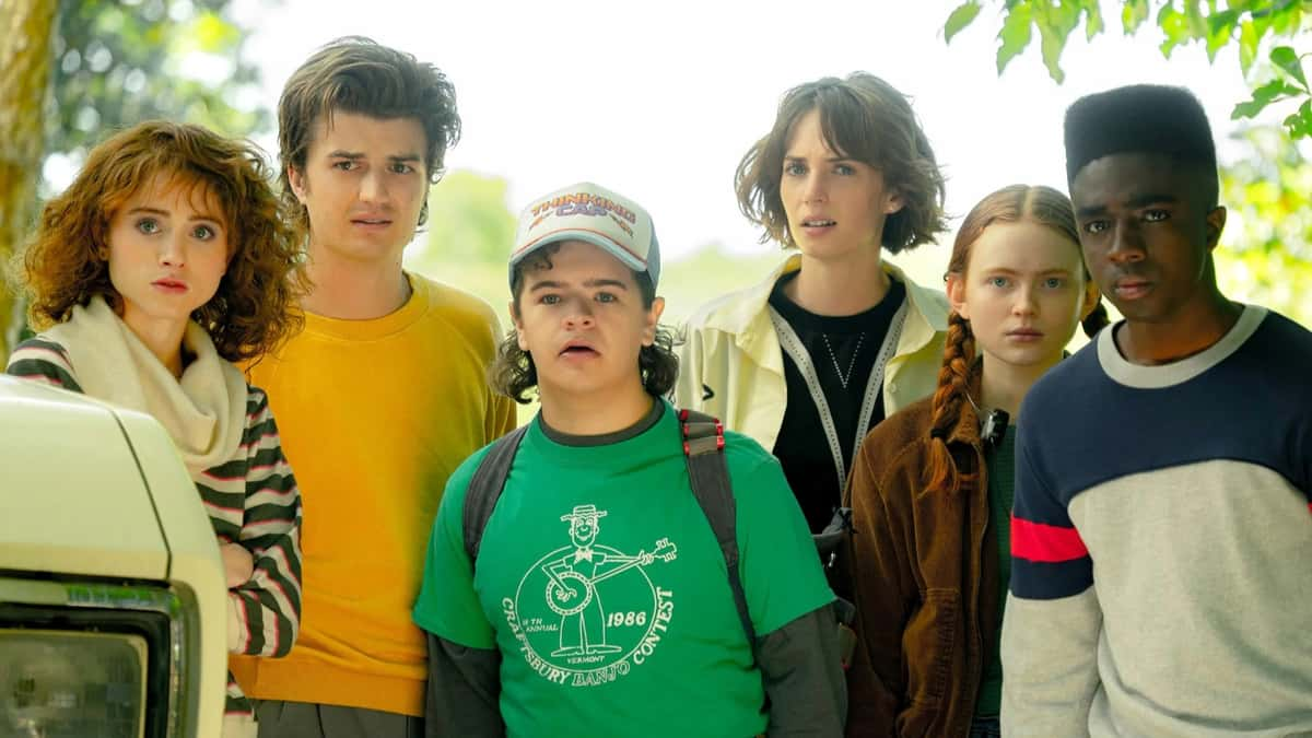 Stranger Things cast in Season 4 standing together and looking past the camera