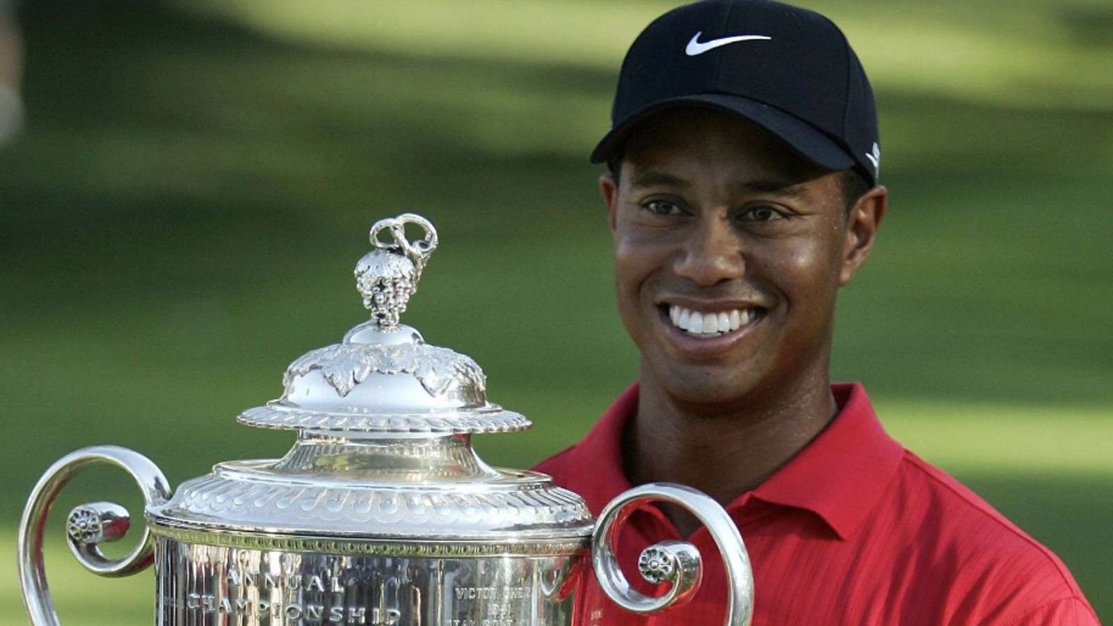 Tiger Woods posing with a trophy