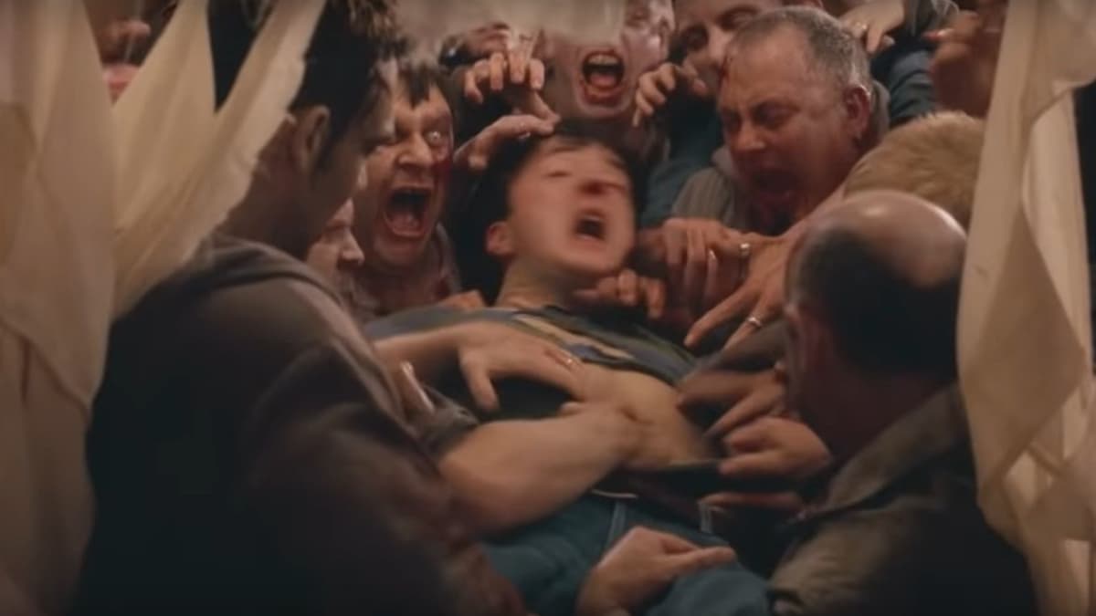 David (Dylan Moran) is dragged through a window by zombies in Shaun of the Dead.