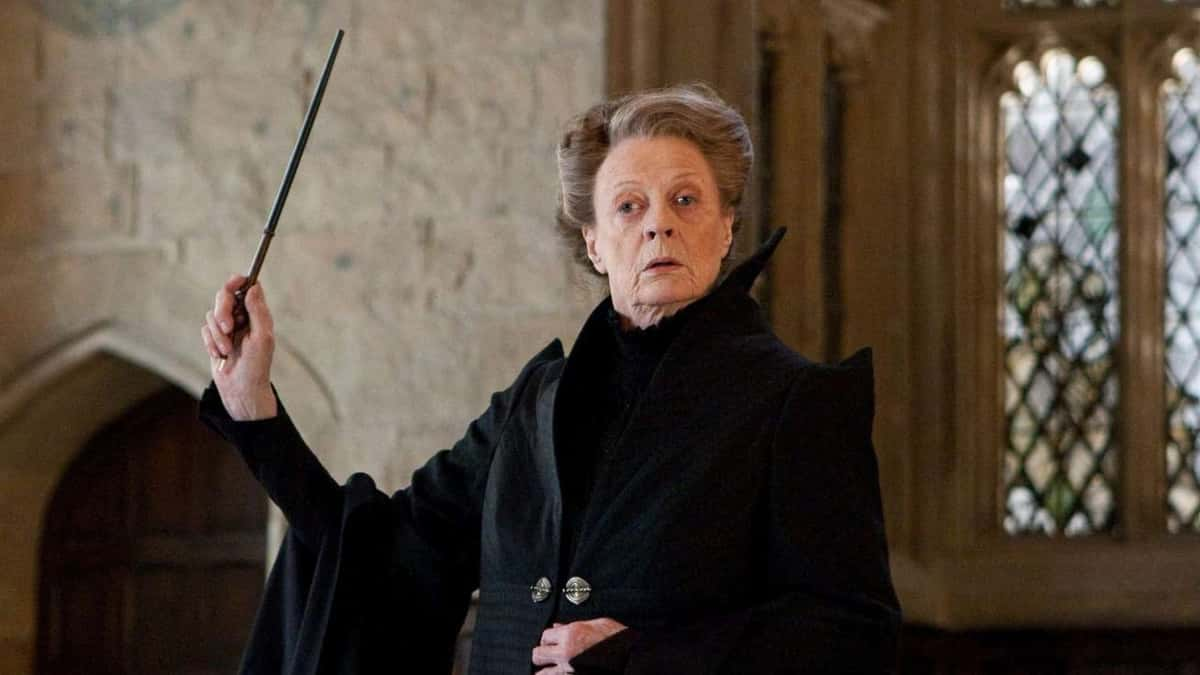 Maggie Smith raises a wand above her head in Harry Potter