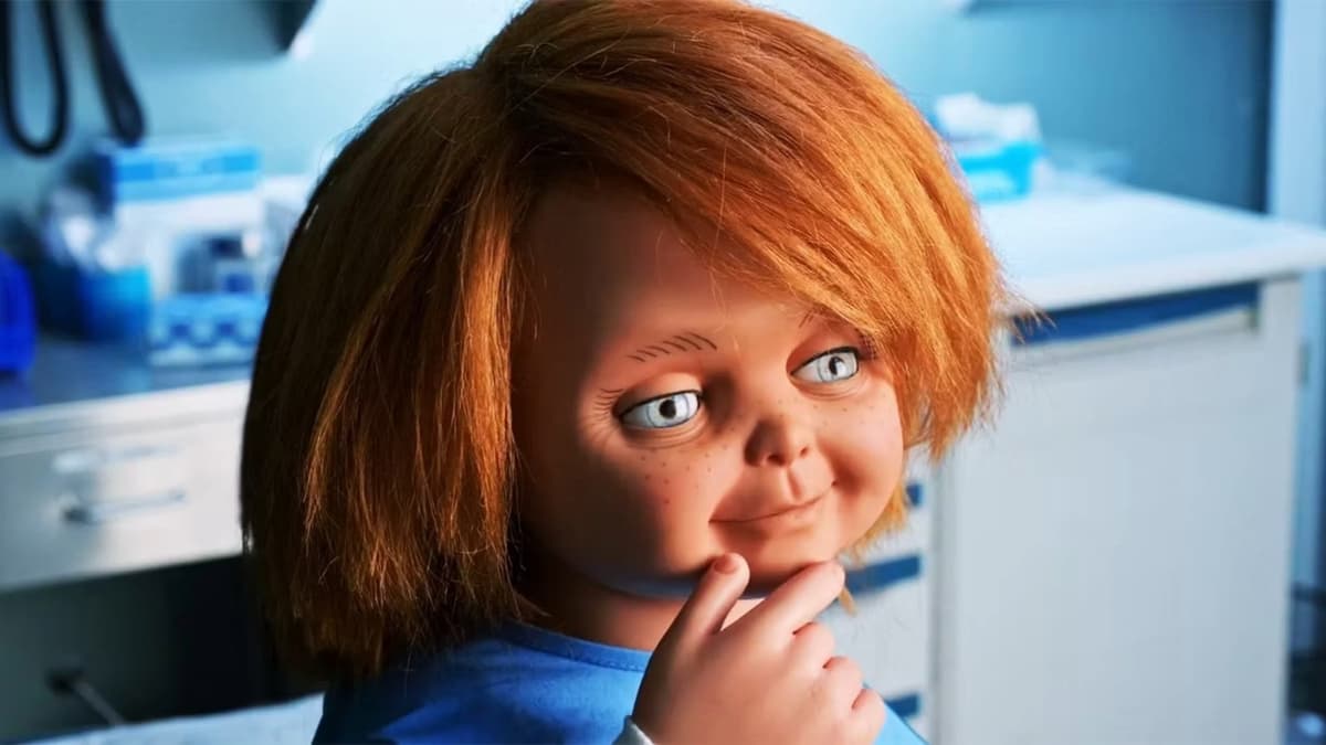 Chucky the doll holding a hand to his face in the tv show