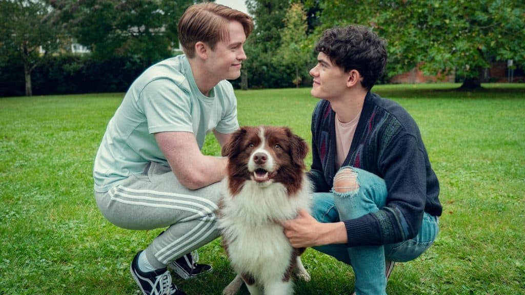 Nick and Charlie pet a dog in Heartstopper Season 3