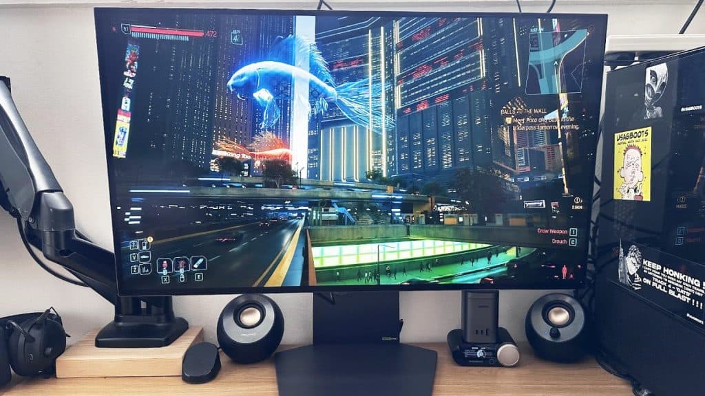 LG monitor on a table with speakers in the background