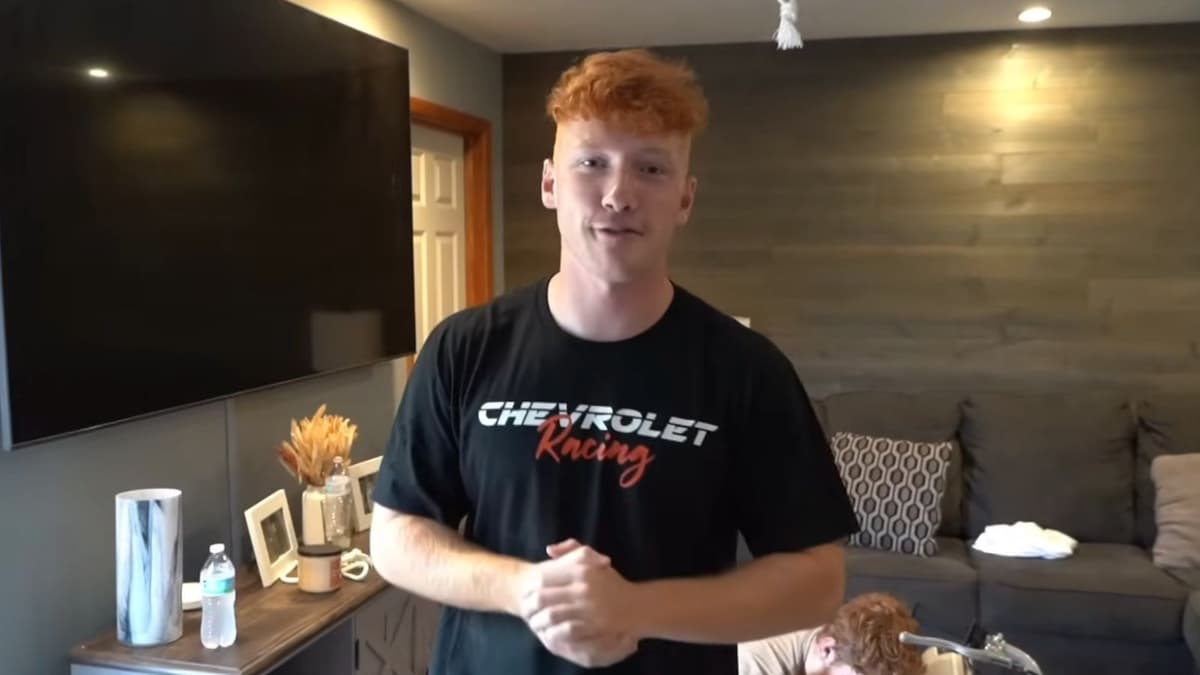 YouTuber Corbin Millet stood in living room in front of tv holding his hands