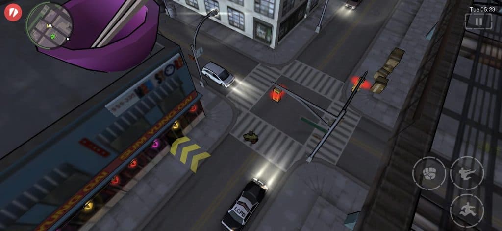 A police car driving around Liberty City, stopped at a crosswalk.