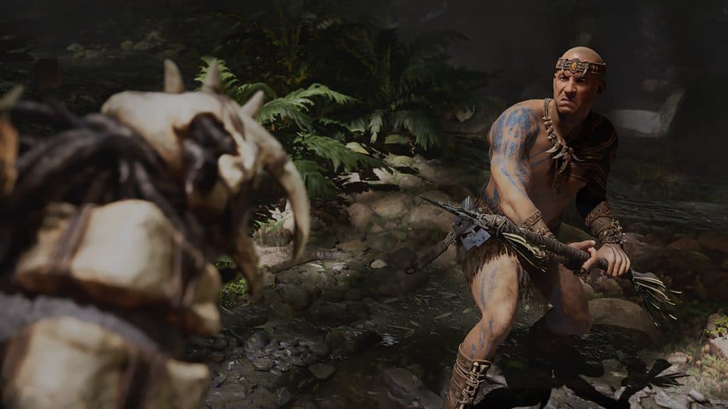 Vin Diesel's character in Ark 2, holding a spear while looking at a dinosaur