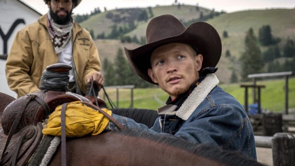 Jefferson White as Jimmy in Yellowstone, saddling a horse