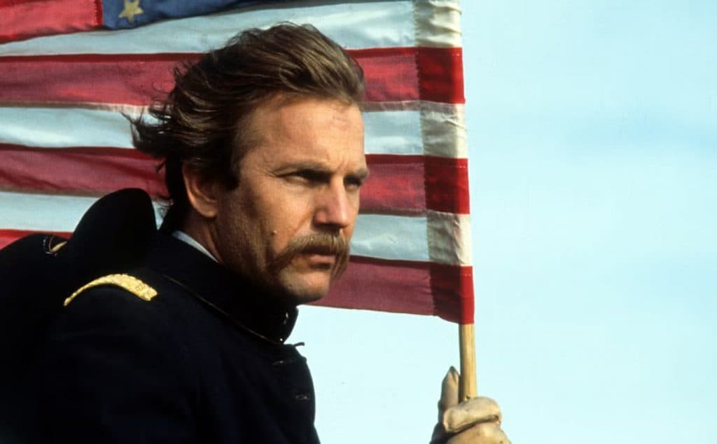 Kevin Costner in Dances With Wolves, holding an American Flag