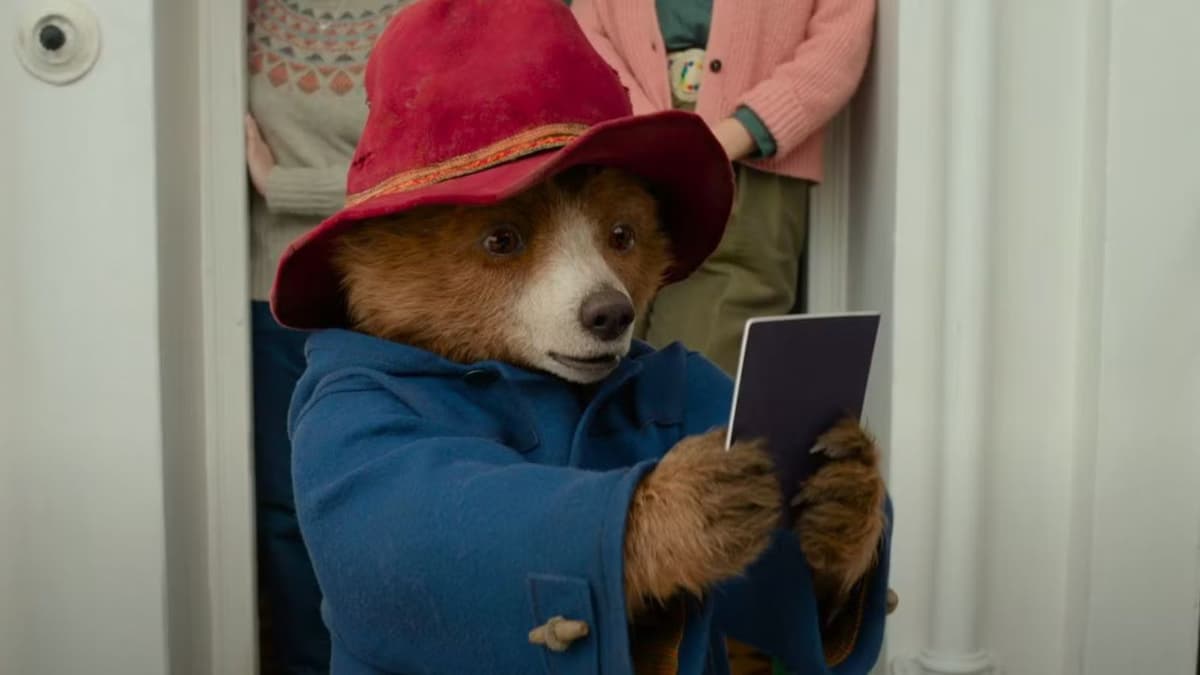 Paddington holds his passport in Paddington in Peru