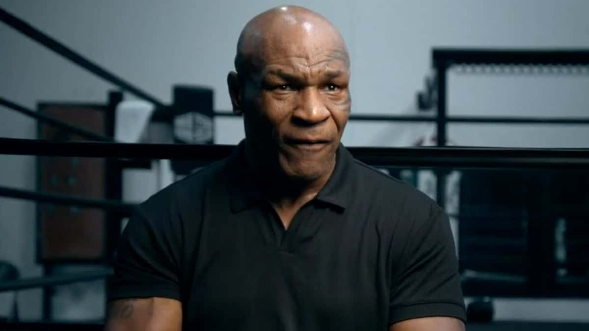 Mike Tyson talking to camera in black shirt