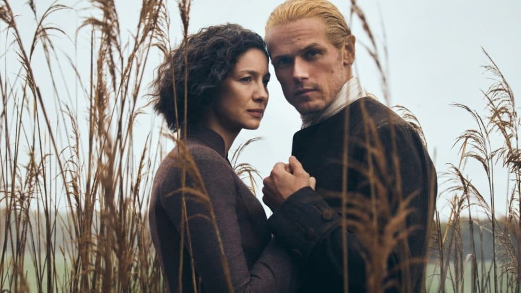 Claire and Jamie in the rushes in Outlander.