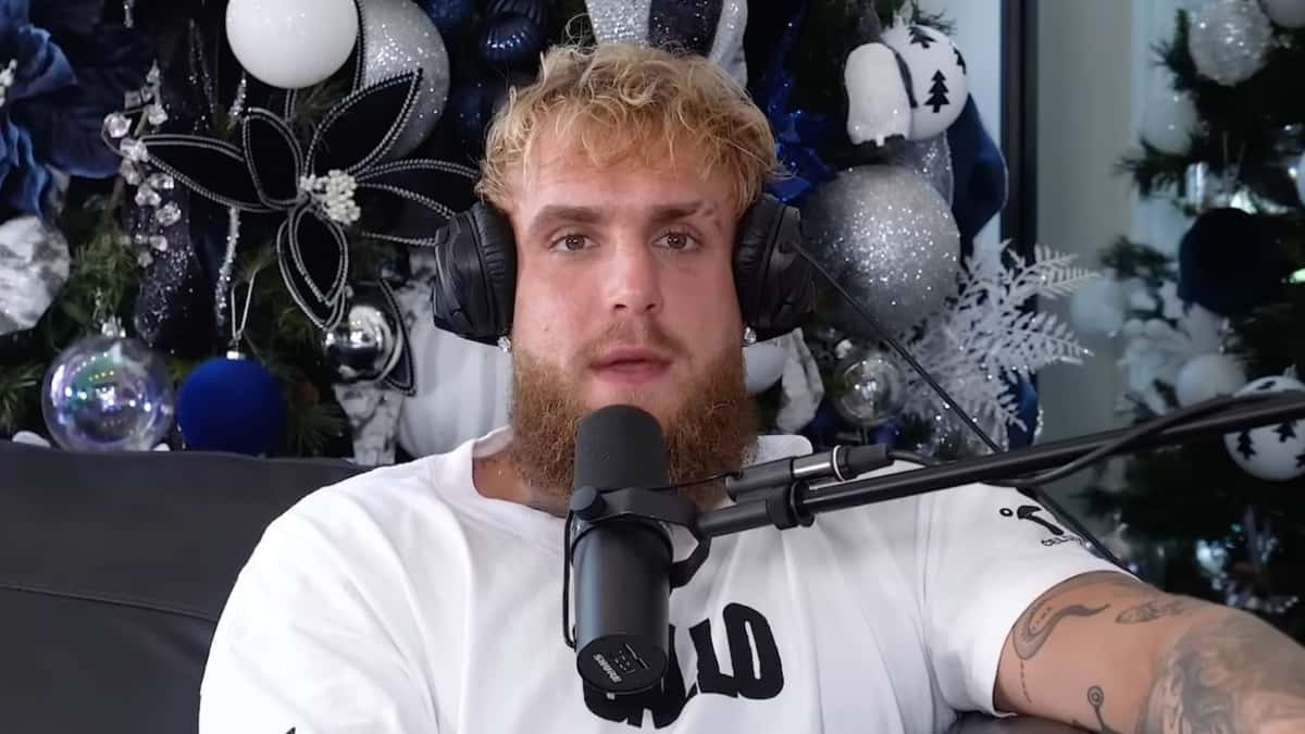 Jake Paul talking to camera in white t-shirt with mic