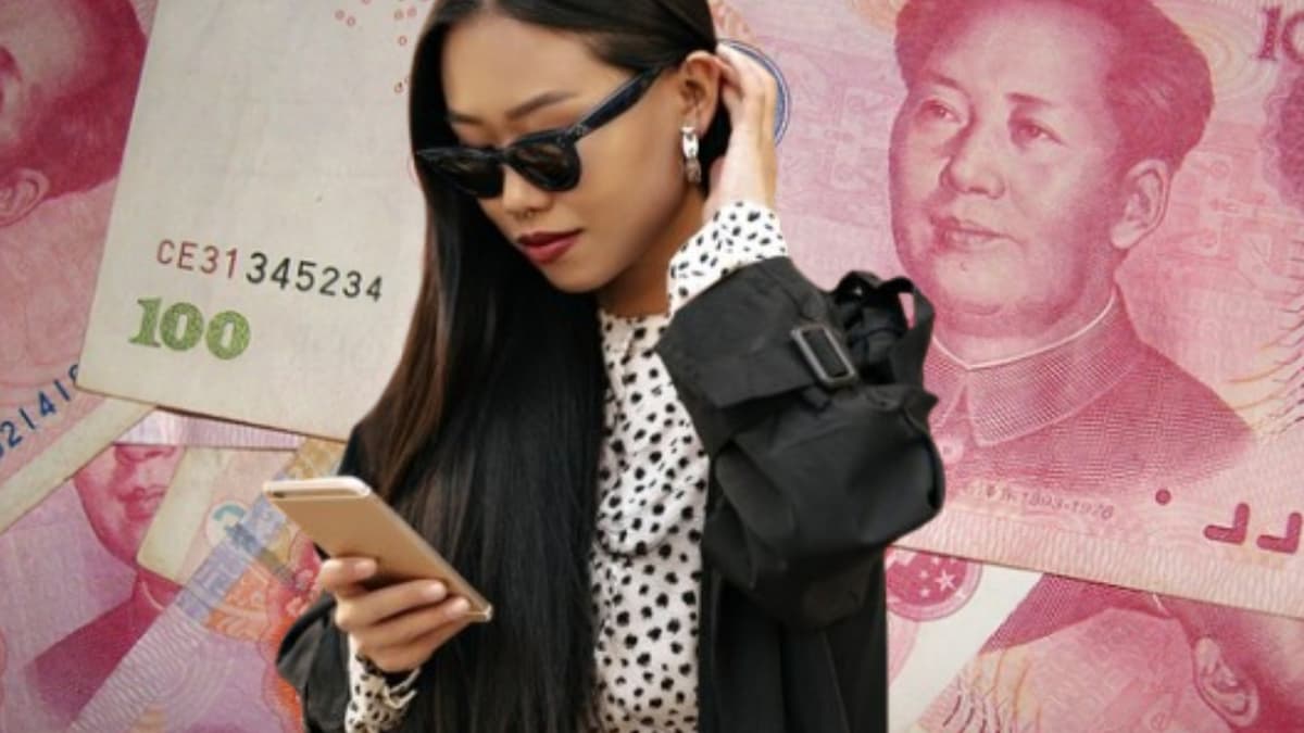 Chinese model checking her phone with money backgrond