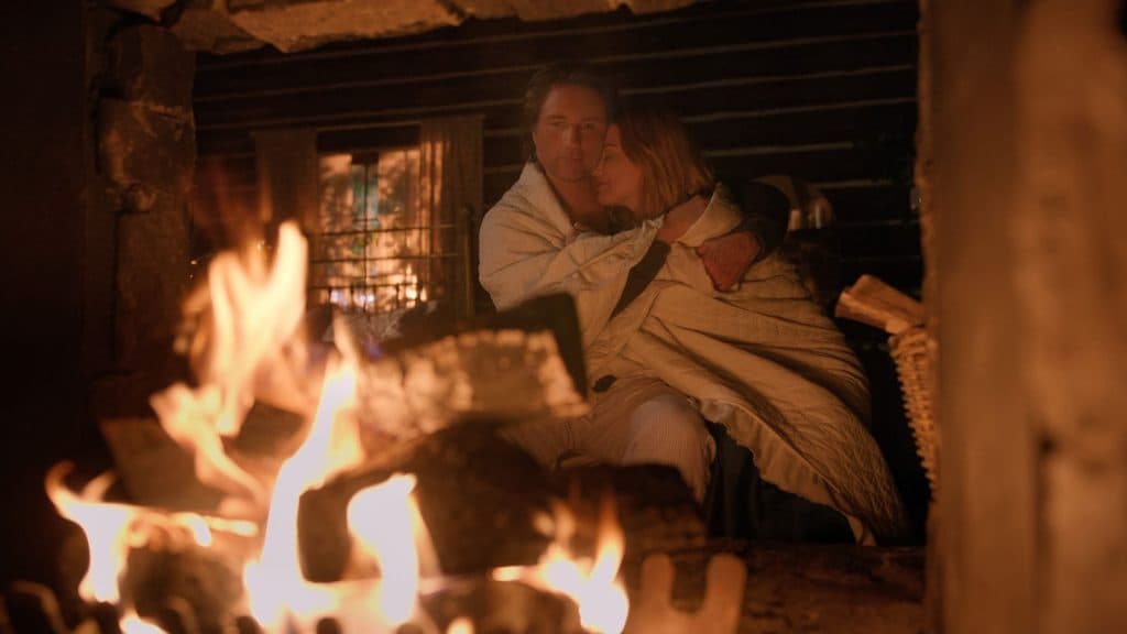 Mel and Jack embrace by the fire in Virgin River Season 6