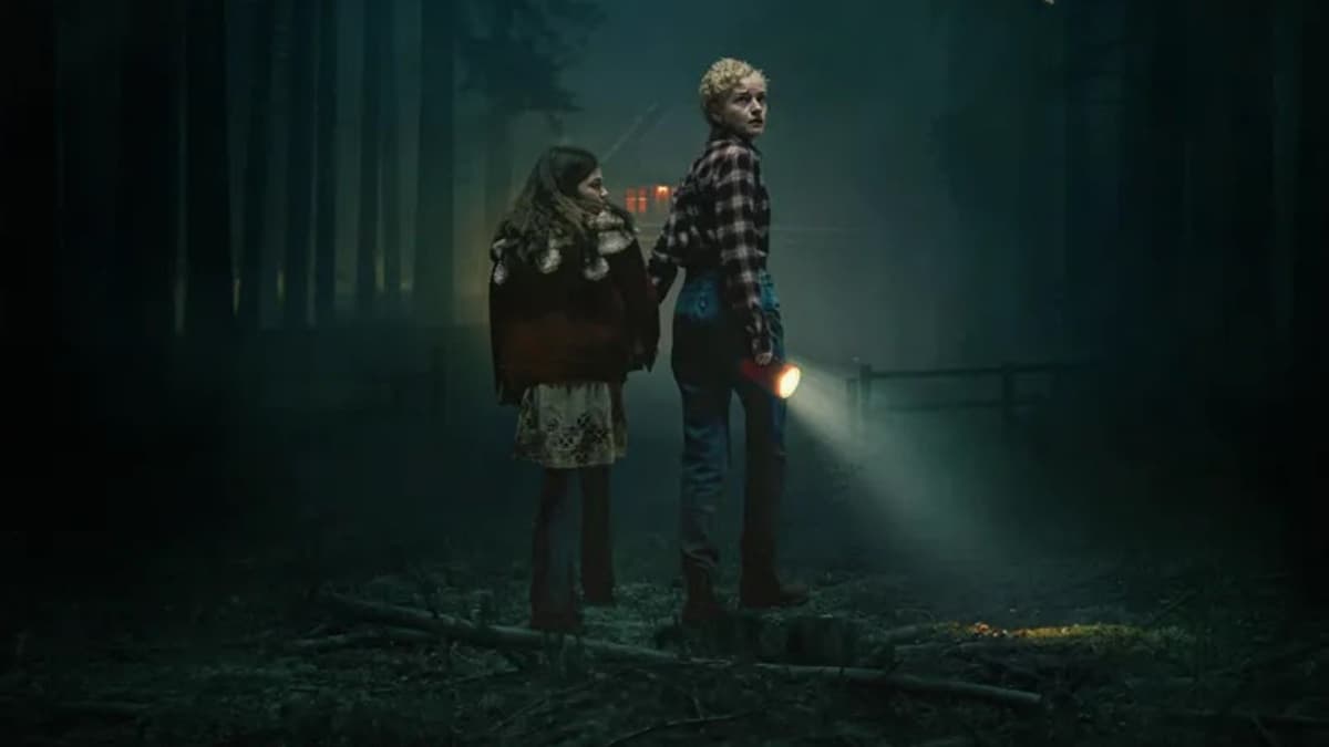 Mother and daughter scared in the woods in The Wolf Man.