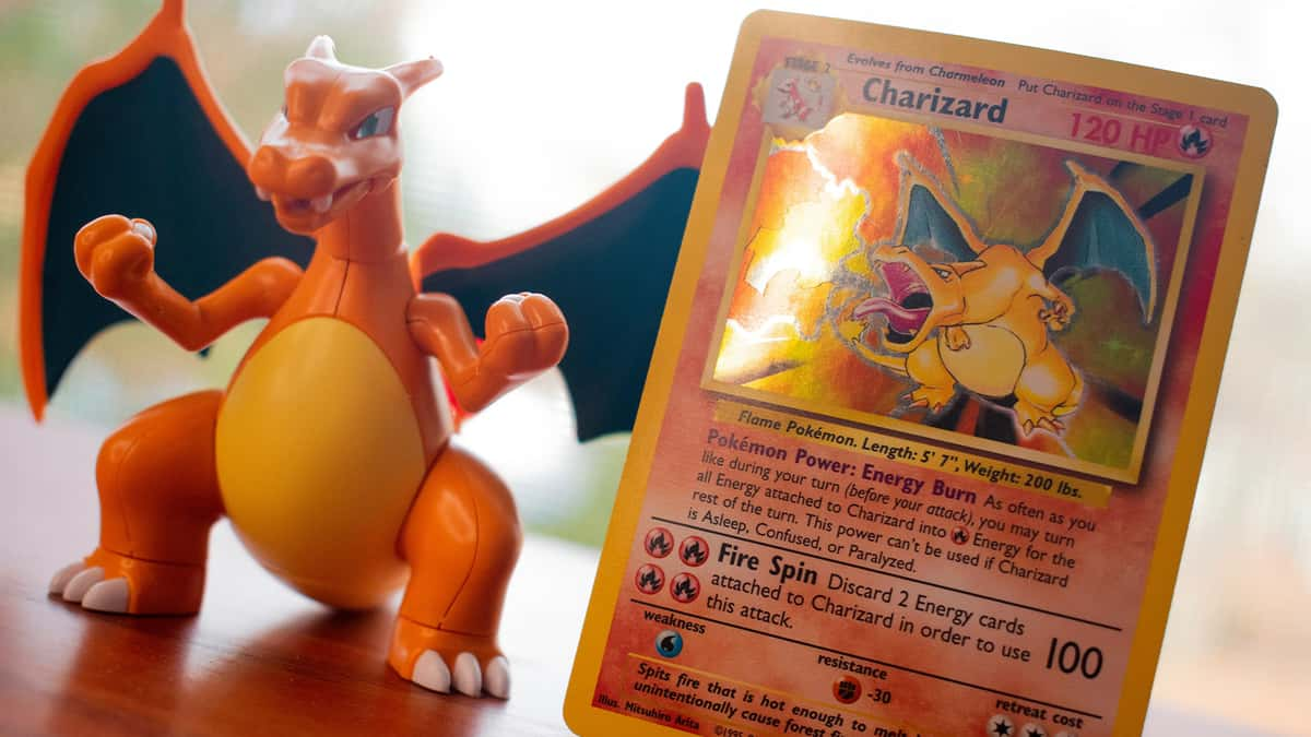 Pokemon TCG Charizard card with matching statue