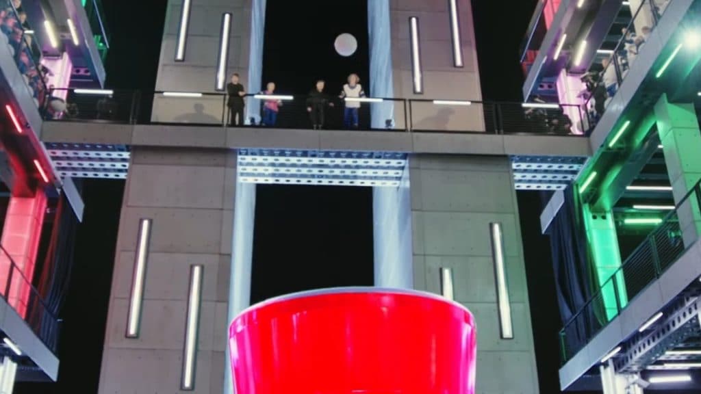 Competitors throw balls into solo cup in Beast Games