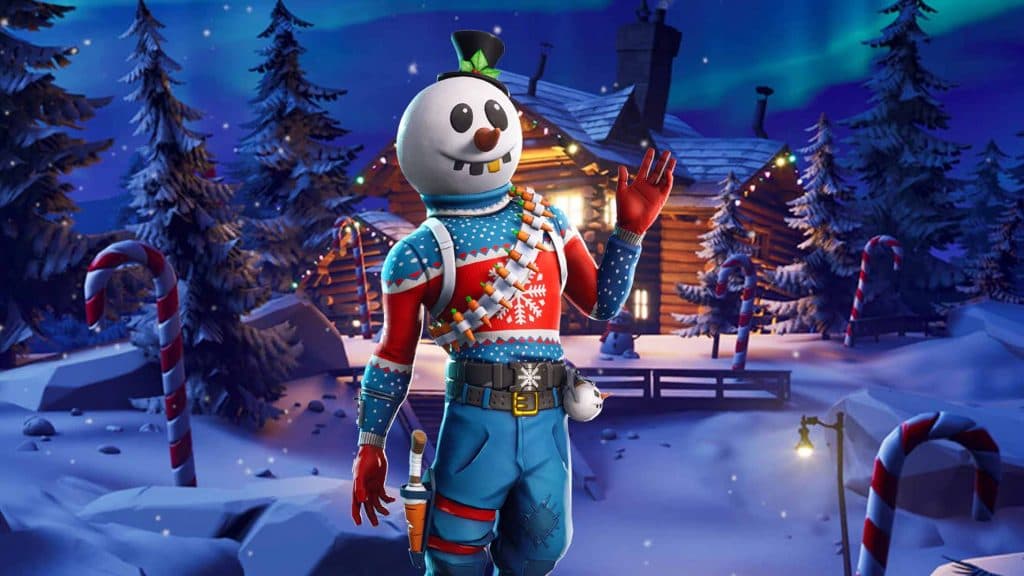 Slusy Soldier, a snowman wearing blue pants and a blue Christmas sweater, standing in front of a log cabin waving