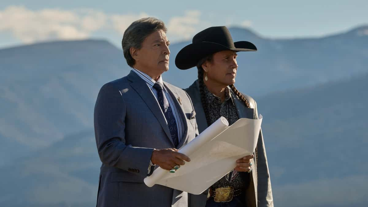 Yellowstone: Mo and Rainwater hold a piece of paper and look out at the mountains