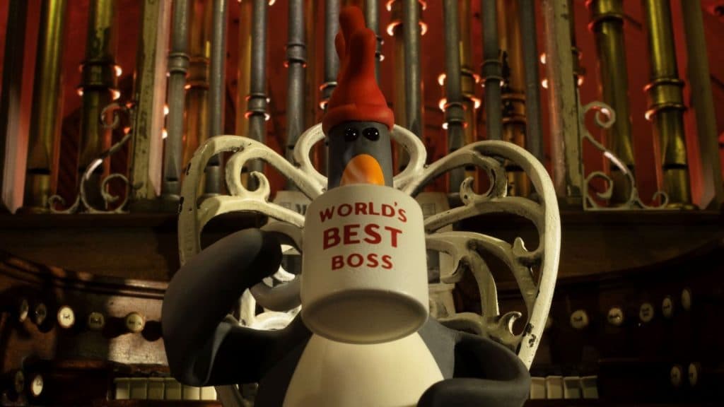 Feathers Mcgraw drinks from a World's Best Boss mug