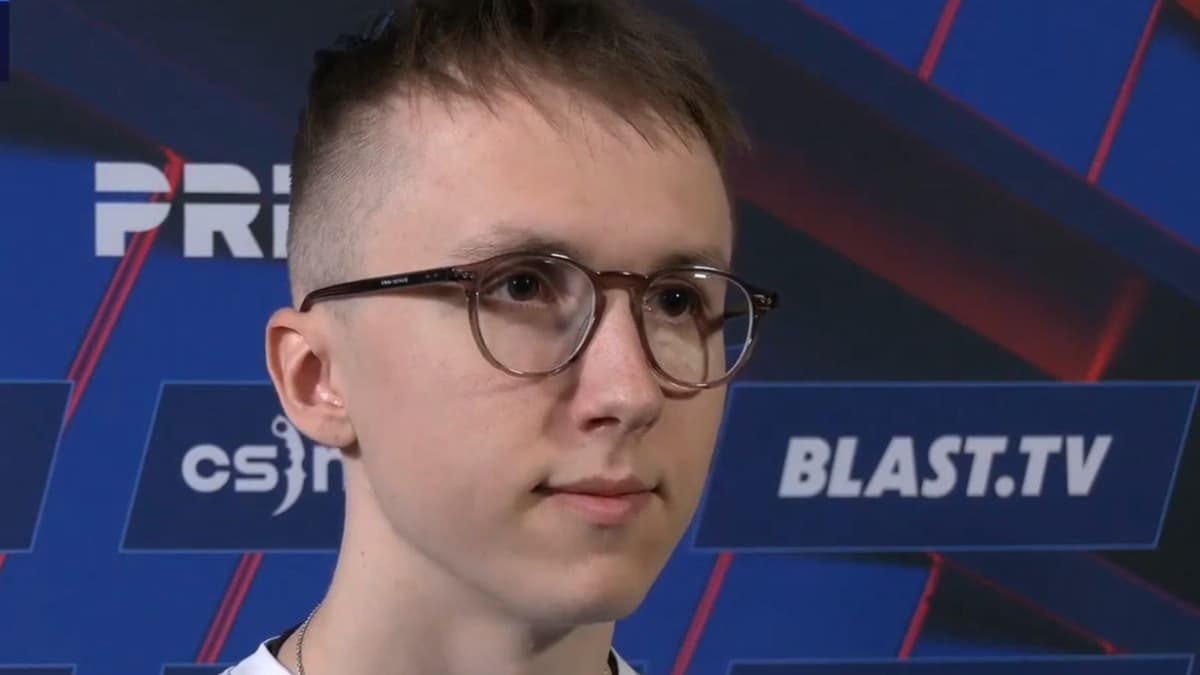 Ropz talking to camera next to blue wall with sponsor names and logos on