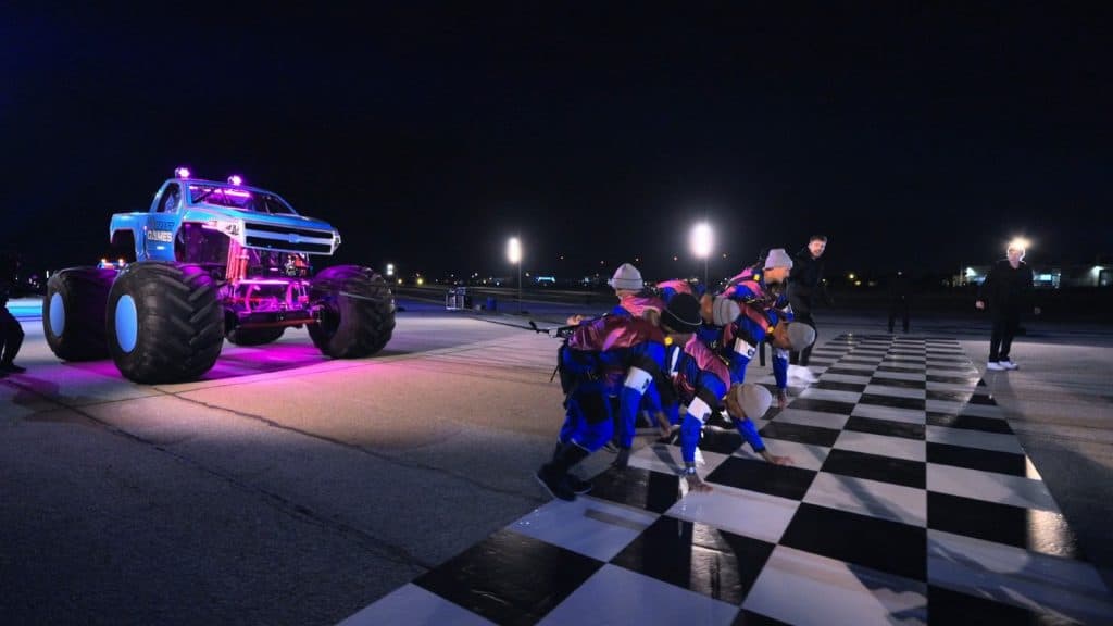 Beast Games players pull a monster truck