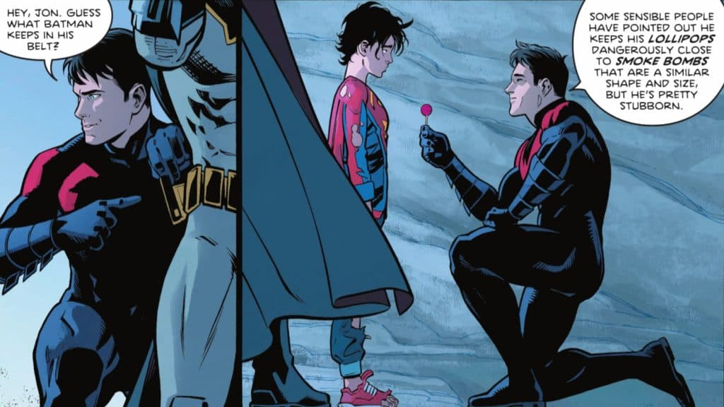 Nightwing offers Jon Kent a lolipop from Batman's belt.