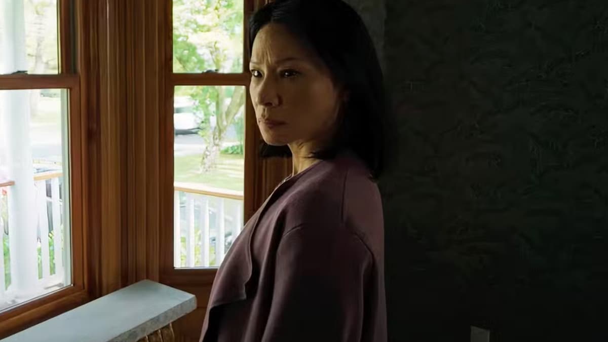 Lucy Liu standing next to a window in Presence.