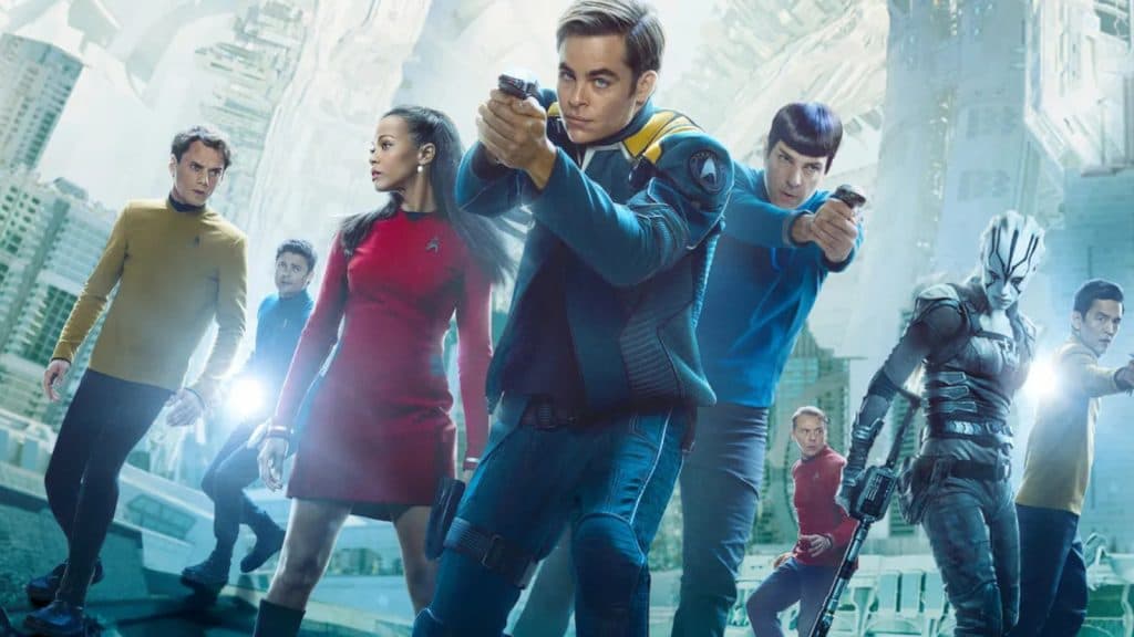 Chris Pine and the cast of Star Trek Beyond point their phasers at an unseen enemy.