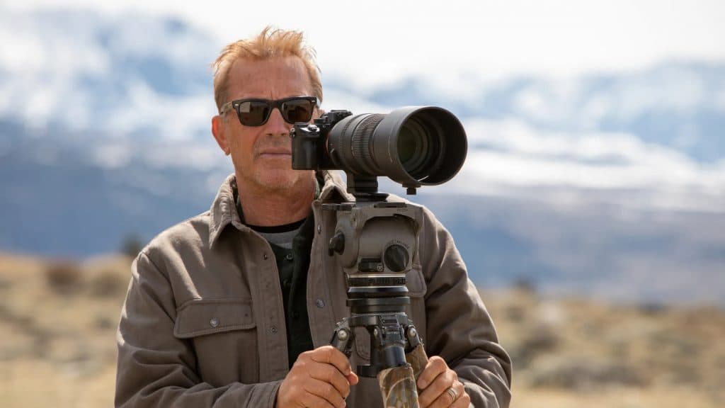 Kevin Costner holding a camera in Yellowstone: One-Fifty