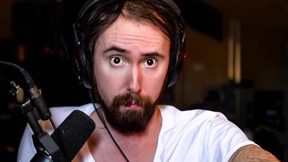 asmongold in a white shirt staring at the camera in his staring room