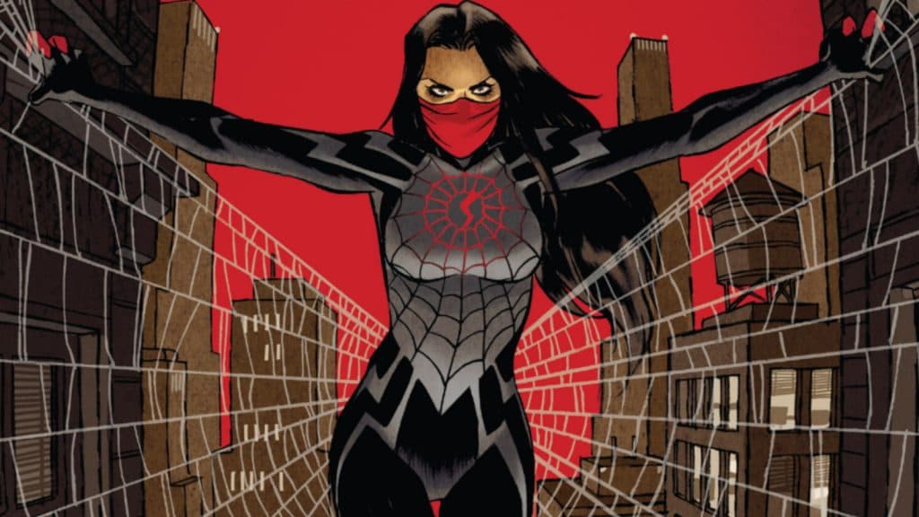 Silk sits in a spider's web looking menacing.