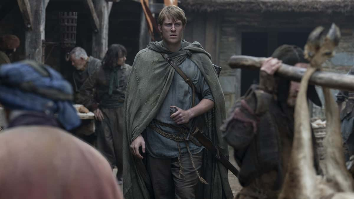 Peter Claffey walking through a village as Dunk in Knight of the Seven Kingdoms.