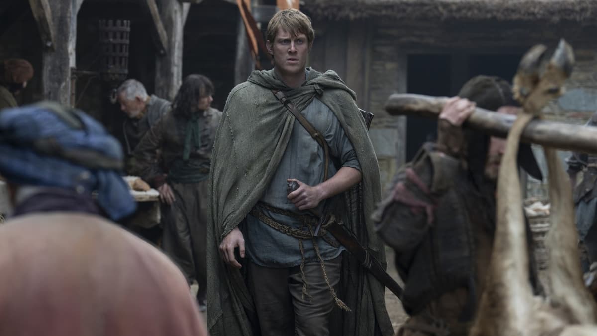 Peter Claffey walking through a village as Dunk in Knight of the Seven Kingdoms.