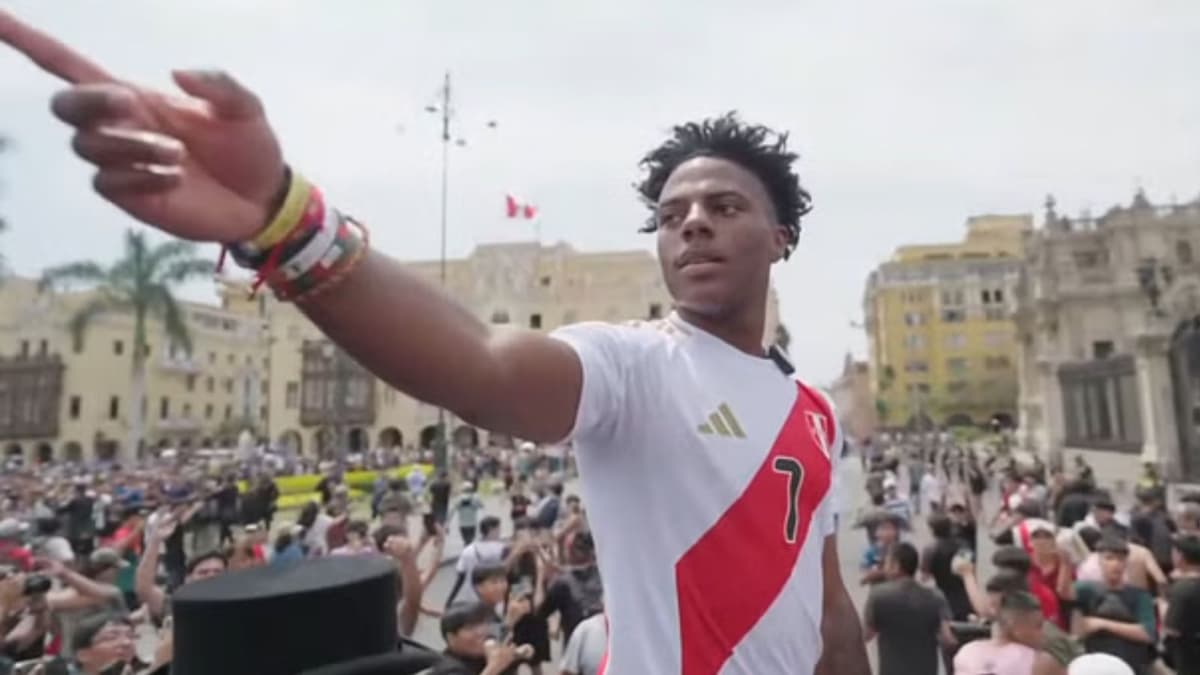 Ishowspeed pointing at crowd in Peru football shirt