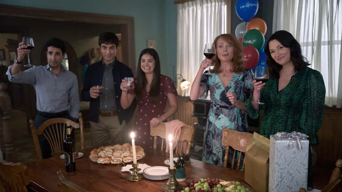 The cast of The Way Home Season 3 make a toast around a dining table