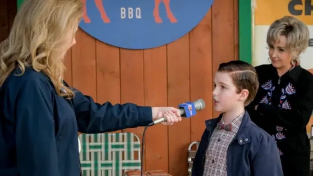 Sheldon being interviews by a news team in Young Sheldon