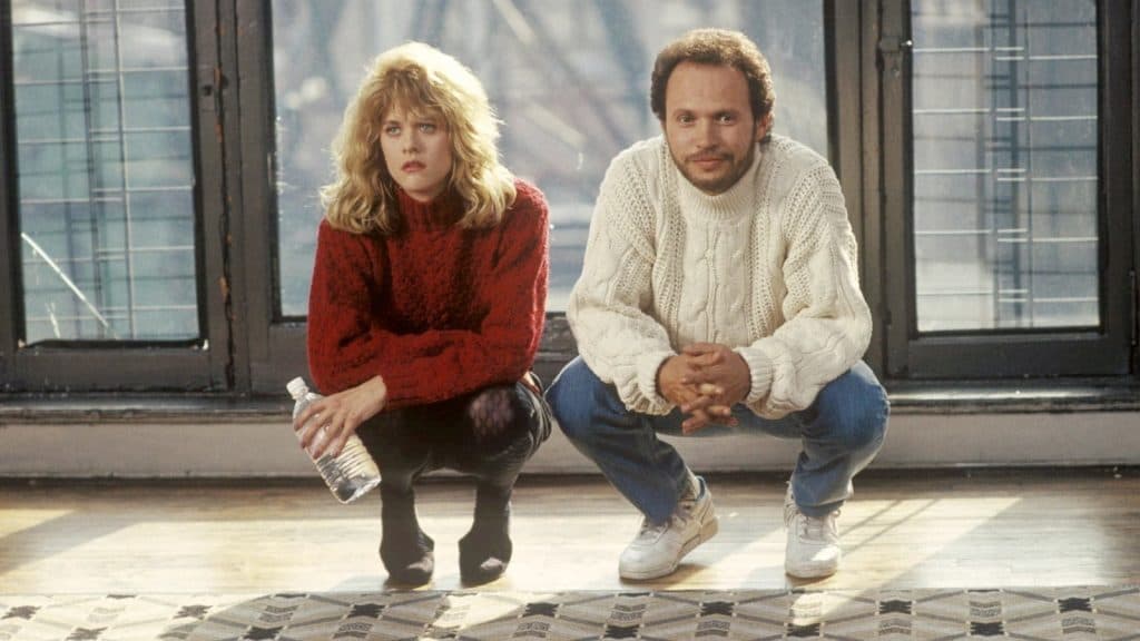 Sally and Harry kneeling down in an empty apartment.