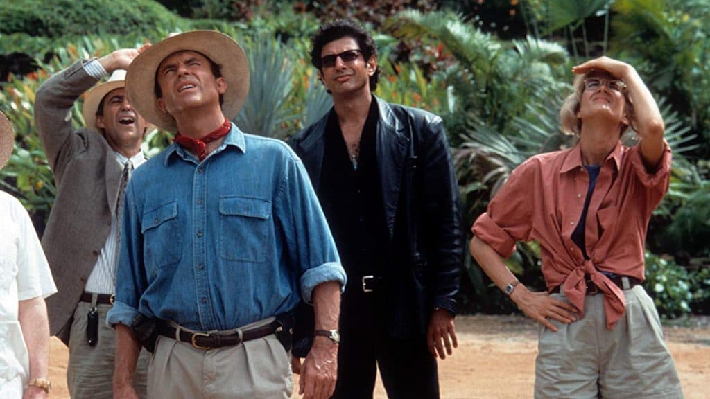 Sam Neill, Jeff Goldblum, and Laura Dern look up at the sky in Jurassic Park