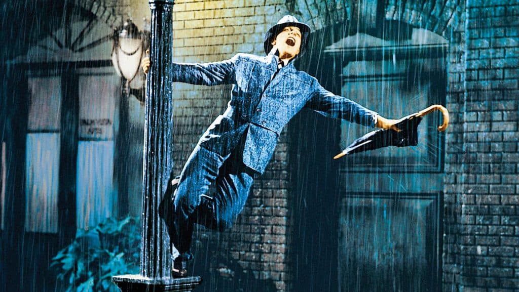 Gene Kelly holding into a streetlamp in Singin' in the Rain