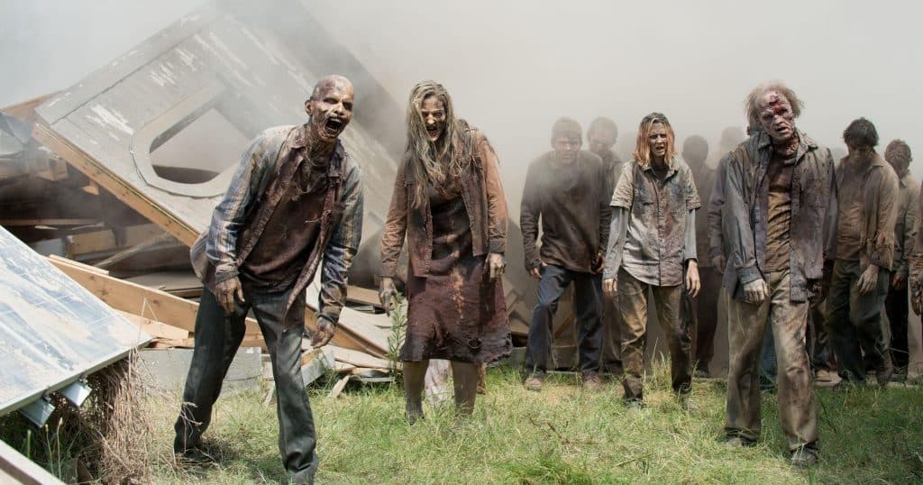 A group of zombies walk towards the camera in The Walking Dead