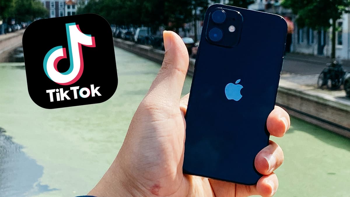 TikTok logo beside a man holding an iPhone